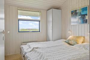 a bedroom with a bed and a window at G112-Lemvig-Anemonevej-12 in Lemvig