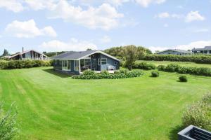 a small house in a yard with a large lawn at G112-Lemvig-Anemonevej-12 in Lemvig