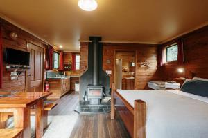 a room with a woodburning stove in a cabin at Cradle Highlander in Cradle Mountain