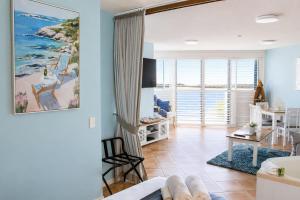 a living room with a view of the ocean at La Promenade Absolute Waterfront Apartments in Caloundra