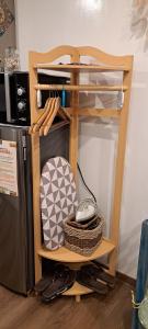 a wooden shelf with a computer mouse on it next to a refrigerator at Megatower 4 Diorite Unit in Baguio +7 photos