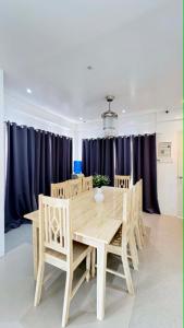 a dining room with a wooden table and chairs at Sergi's Resort and Hotel in Palompon