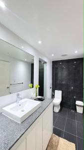 a bathroom with a white sink and a toilet at Sergi's Resort and Hotel in Palompon +34 photos