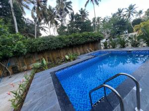 a swimming pool with a staircase next to a resort at Hossana 5BHK Private Villa with Pool near Kovalam Beach in Kovalam