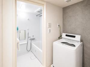 a bathroom with a washer and dryer in it at NEW OPEN!! SLEEPLAB 池袋 -ikebukuro- in Tokyo