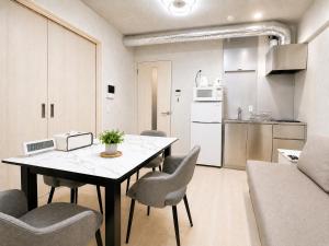 a kitchen and dining room with a table and chairs at NEW OPEN!! SLEEPLAB 池袋 -ikebukuro- in Tokyo