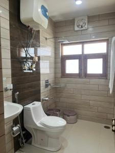 a bathroom with a toilet and a sink at p&q's guest house in Srinagar +55 photos
