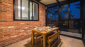 a table with food on it on a patio at Goseong Pinetree Pension in Goseong