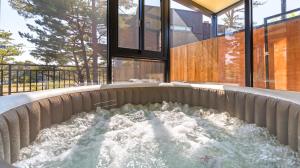 a water fountain in the middle of a building at Goseong Pinetree Pension in Goseong +1 photo