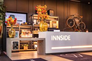 a store with vases of flowers on a counter at INNSiDE by Meliá Manchester in Manchester