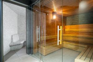 a sauna with a bench and a chair in a room at INNSiDE by Meliá Manchester in Manchester
