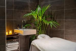 a bathroom with a sink and a plant at INNSiDE by Meliá Manchester in Manchester