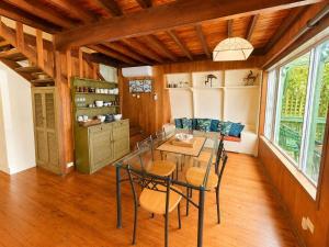 a dining room with a glass table and chairs at Cottage on the Lake - peaceful Burrill Lake escape in Burrill Lake