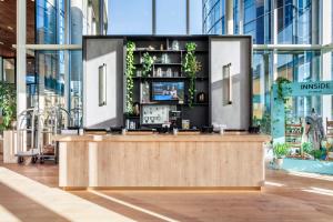 a kiosk in a building with a tv on it at INNSiDE by Meliá Amsterdam in Amsterdam