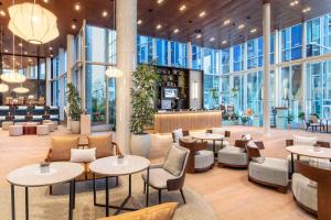 a restaurant with tables and chairs and windows at INNSiDE by Meliá Amsterdam in Amsterdam +67 photos