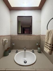 a bathroom with a sink with a mirror and a mirror at Casa Huatulco in Santa Cruz Huatulco +61 photos
