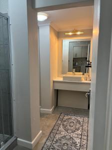 a bathroom with a sink and a mirror at The Red Couch Accommodation in Tsumeb