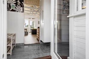 a hallway with a glass door leading to a kitchen at 13383-Asnaes-Glentevej-15 in Asnæs