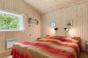 a bedroom with a bed and a window at 10039-Nykobing-Sj-Rishoj-Sidevej-9 in Nakke