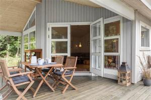 a patio with a table and chairs on a house at 10039-Nykobing-Sj-Rishoj-Sidevej-9 in Nakke +11 photos