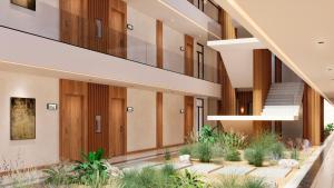 an internal view of a building with stairs and plants at Meliá Durres Albania in Draç