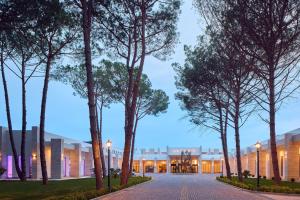 a row of trees in front of a building at Meliá Durres Albania in Draç