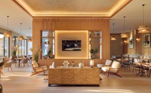 a lobby of a hotel with tables and chairs at Meliá Durres Albania in Draç