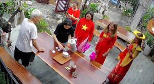a group of people standing around a wooden bench at Champs De Tam Coc Hotel in Vũ Lâm