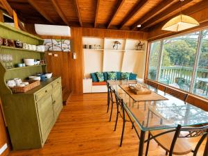 a kitchen with a table and chairs in a room at Cottage on the Lake - peaceful Burrill Lake escape in Burrill Lake +9 photos