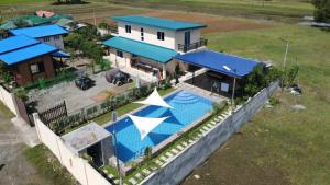 an aerial view of a house with a swimming pool at BalaiBesa Transient House in Lingayen