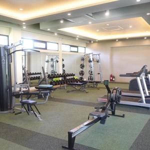 a gym with several tread machines in a room at Alabang Staycation by East Bay Residence in Sampong