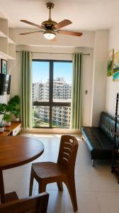 a living room with a couch and a table at Alabang Staycation by East Bay Residence in Sampong