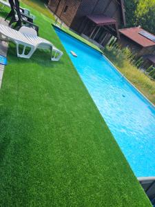 an overhead view of a swimming pool with a bench and grass at Natura na Uni in Bihać