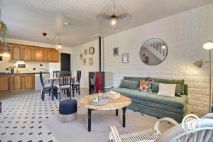 a living room with a couch and a table at Le clos kerroux in Noyal-Muzillac