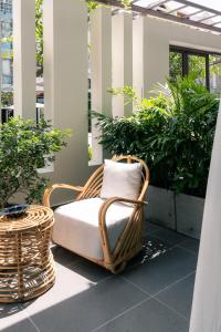 a wicker chair sitting on top of a patio at Harbor Point Quoc Huong, Thao Dien in Ho Chi Minh City