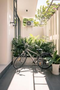 a bike parked outside of a building with plants at Harbor Point Quoc Huong, Thao Dien in Ho Chi Minh City