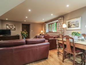 a living room with a couch and a table at The Lodge Farm Barn in Kerne Bridge