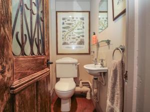 a bathroom with a toilet and a sink at The Lodge Farm Barn in Kerne Bridge +23 photos