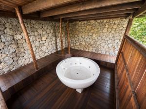 a bathroom with a toilet in the middle of a building at The Secret Sanctuary in Kuching +27 photos