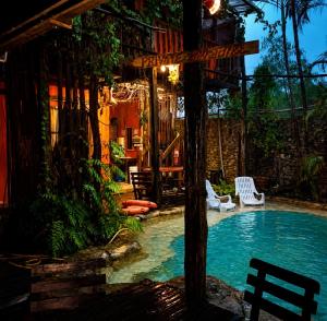 a swimming pool in front of a house at The Secret Sanctuary in Kuching