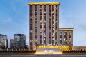 a large building with a sign in front of it at Mercure Beijing Lize Road in Beijing