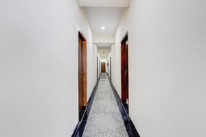 an empty corridor of a white building with a hallway at Collection O Sadar Bazar Gurgaon in Gurgaon