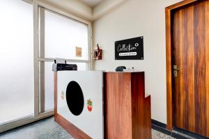 a refrigerator in a room with a door at Collection O Sadar Bazar Gurgaon in Gurgaon +19 photos