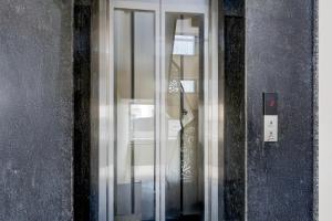 a glass door of a building with a sign in it at Collection O Sadar Bazar Gurgaon in Gurgaon