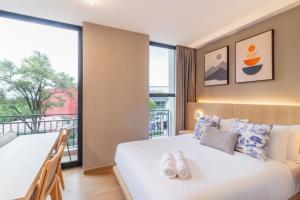 a bedroom with a bed and a large window at Myla Magnolia in Mexico City