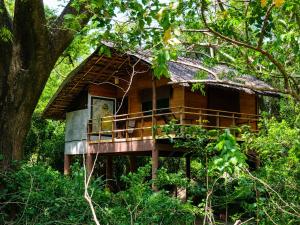 a tree house in the middle of a forest at Tree House Cabana Sigiriya in Sigiriya