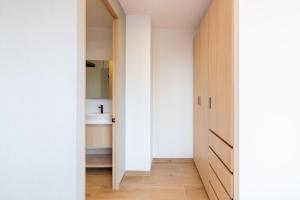 a hallway leading to a bathroom with a sink at Myla Magnolia in Mexico City +96 photos