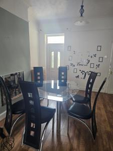 a dining room with a glass table and chairs at Marina Bed Liverpool City LFC in Liverpool