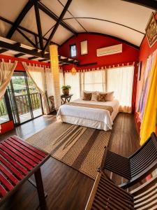 a bedroom with a bed in a room with red walls at The Secret Sanctuary in Kuching