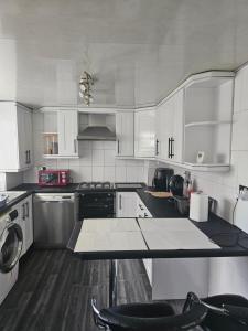 a kitchen with white cabinets and a counter top at Marina Bed Liverpool City LFC in Liverpool